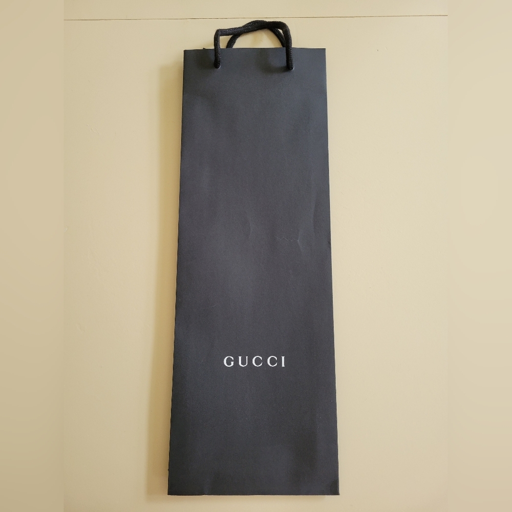 Authentic Gucci gift tote black and white paper shopping bag. 6.25x18”